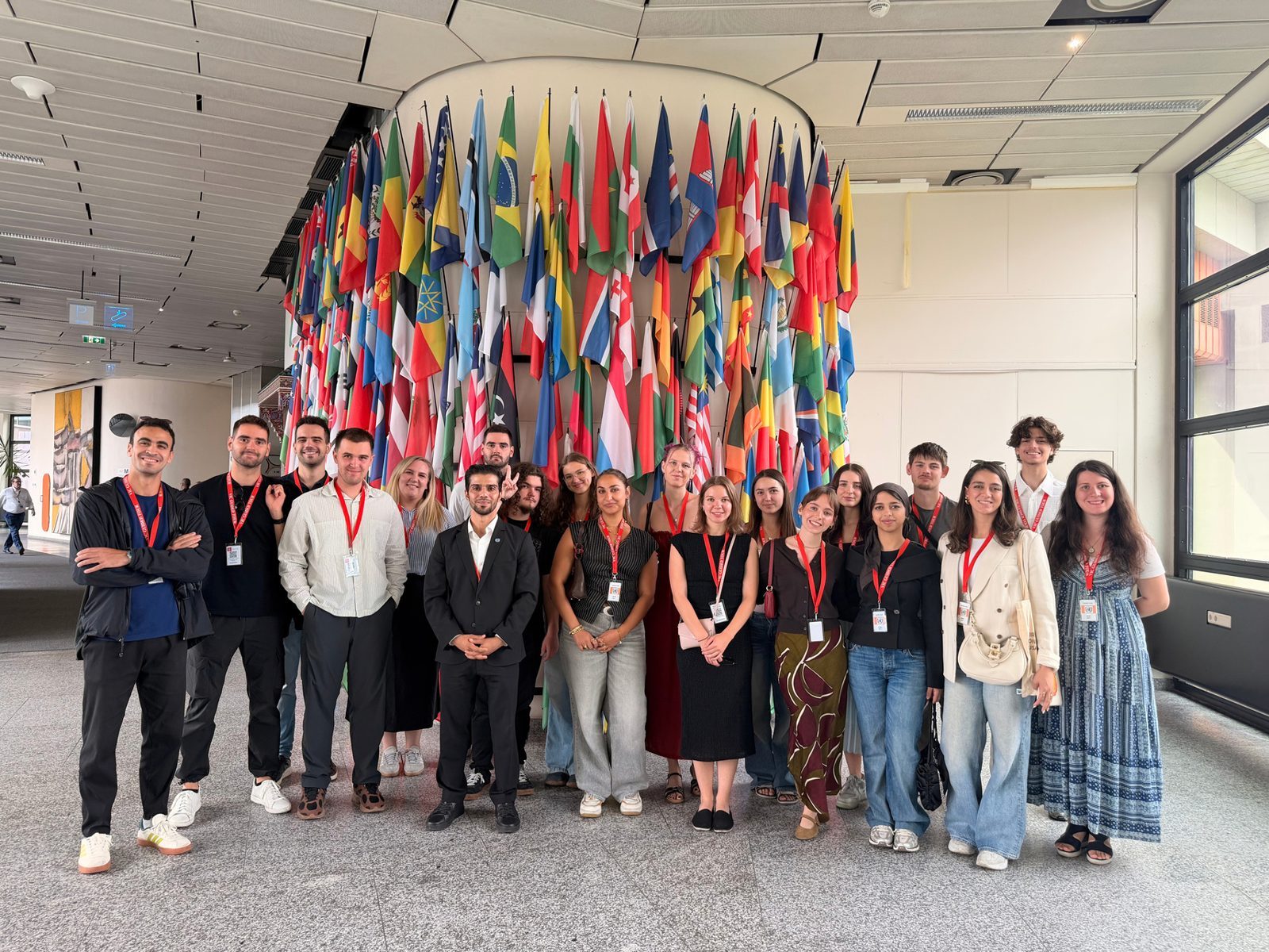 Unsere Gruppe vor einer Wand mit Nationalflaggen bei einem Study Visit