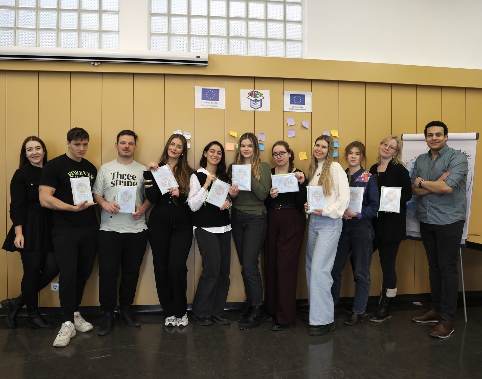 Youth workers holding copies of the SDGs Guidebook